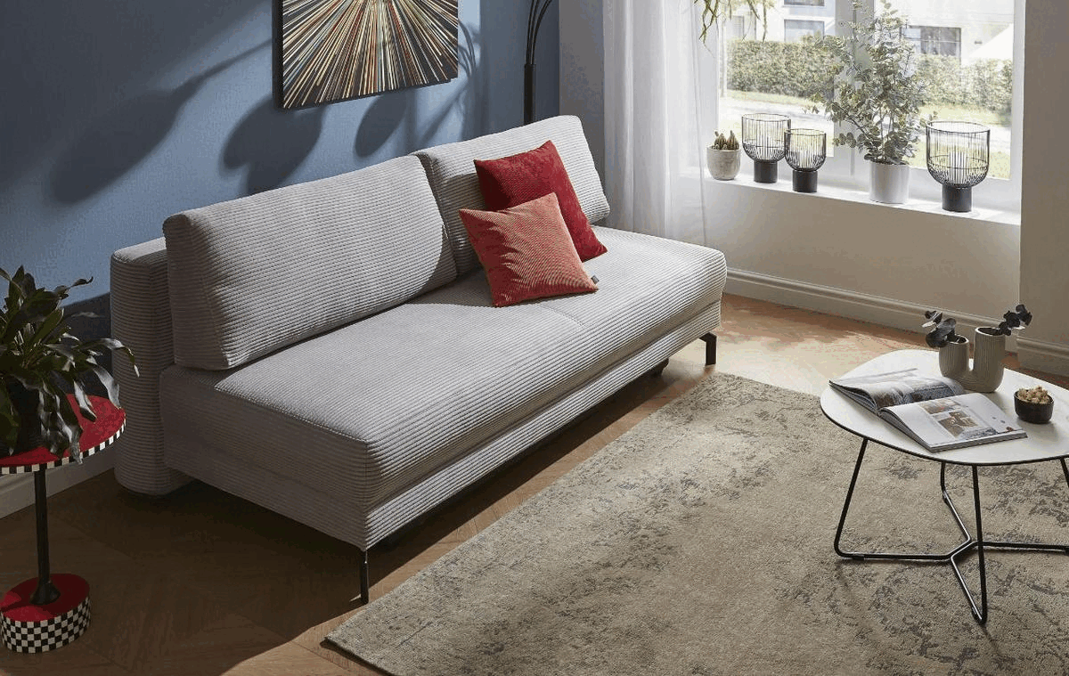 Animation eines grauen Cord Sofas, das zum Bett umgebaut wird.