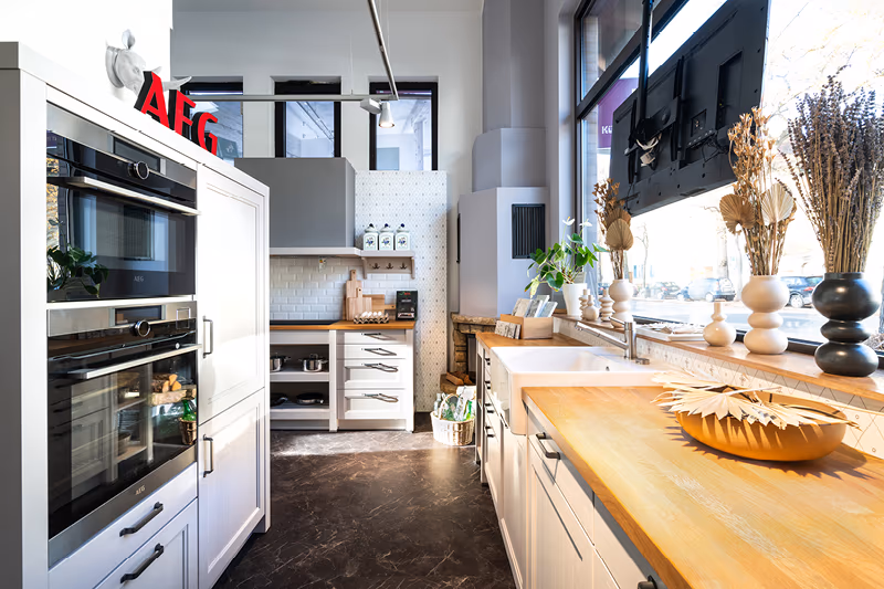 Country Kueche mit EInbaubackoefen und hoelzerner Arbeitsplatte im Kuechenhaus Gruber