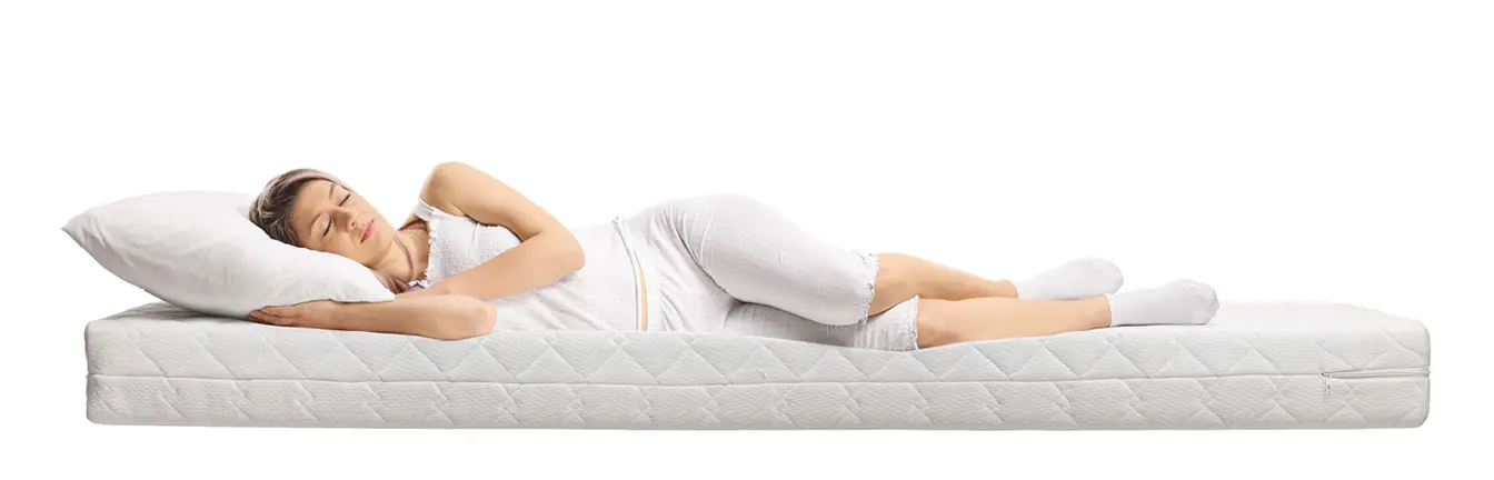 Frau liegt entspannt auf Matratze.