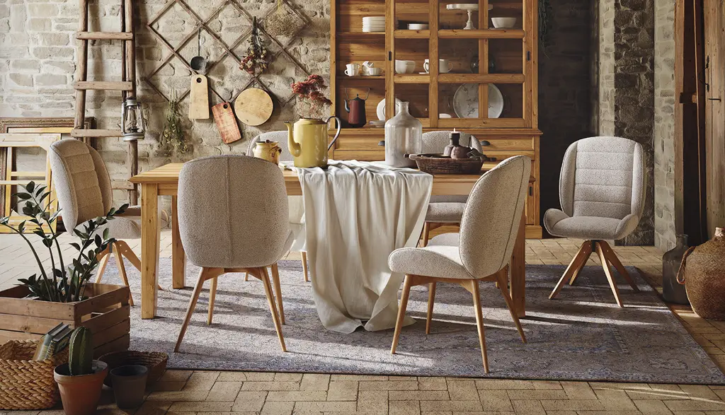 Urig eingerichtetes Esszimmer, mit Holzmöbel und stoffbezogenen Stühlen