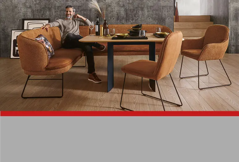 Mann in Sitzecke am Esstisch