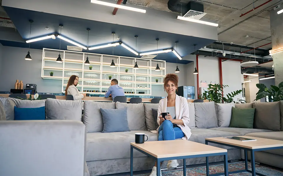 Gemütliche Aufenthaltsecke mit Kaffee-Theke im Hintergrund.