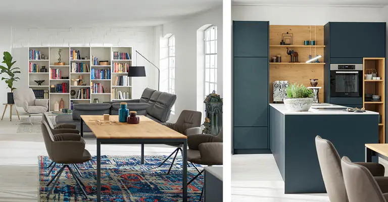 Weitflächige Wohnung mit verschiedenen Ansichten. Wohnraum mit Bücherregal, weite City-Loft Küche und hohe Fenster.