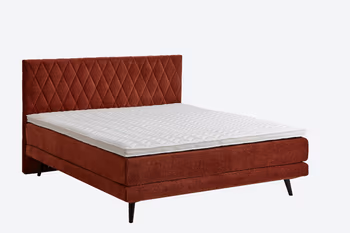 Rotes Boxspringbett mit rautensteppung am Kopfteil