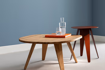 RAUM.FREUNDE SIGNE Beistelltisch aus rotem Metall und Couchtisch aus massiver Eiche