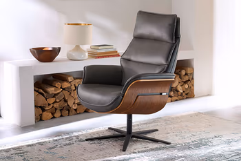 Schwarzer Design Relaxsessel mit dunkler Holzschale an den Armlehnen.