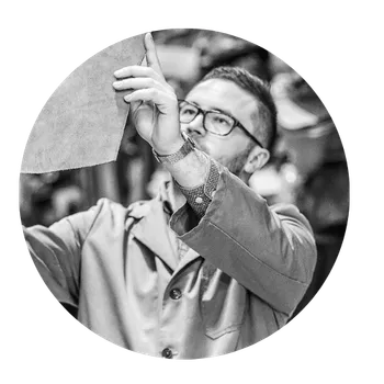 Mann hält einen Werkstoff in einer Möbelproduktion ins Licht.