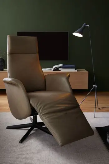 Beiger Relaxsessel mit Lederbezug und schwarzem Sternfuß mit ausgeklappter Fußlehne.
