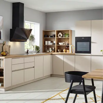 Helle Winkelkueche mit cremefarbenen Fronten und dunkelgrauem Dunstabzug.