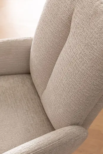 Detailbild von Rückenlehne eines Esszimmerstuhls in beigem Stoff.