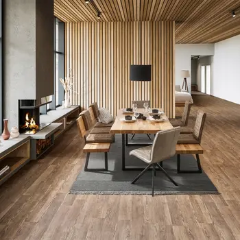 Esstisch mit Baumkante und Kufenfußgestell aus schwarzem Metall um den dazu passende Sitzbänke mit Rückenlehne und braunen Sitzpolstern stehen.