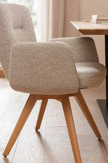 Armlehnstuhl mit ergonomischer Sitzschale in beigem Stoff und mit Gestell aus Wildeiche.