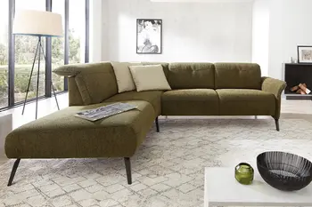 Grünes Ecksofa mit schwarzen Beinen.