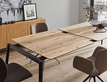 Ausziehbarer Esstisch aus massiver Holzplatte mit modernem Metallgestell in heller Wohnumgebung – stilvolle Kombination aus Funktionalität und zeitgemäßem Design.