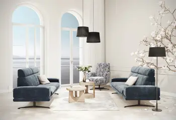 Sessel Charlotte in blumigem Stoffbezug neben Sofa Hubertus in blau von Comfort Republic