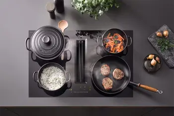 Kochfeld mit integriertem Dunstabzug auf dem alle Kochplatten belegt sind.