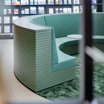 Detailaufnahme einer runden, gepolsterten Sitzbank, grün