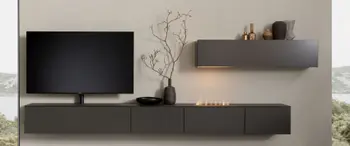 Schwarze Design Wohnwand mit integriertem Deko Kamin.