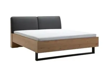 Bett mit Metallkufe und Polsterkopfteil
